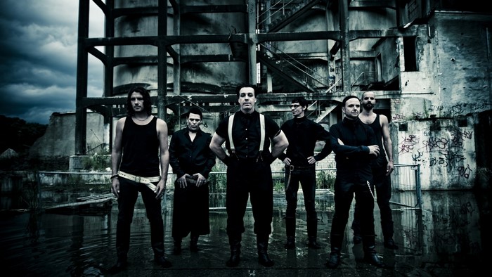 Rammstein band members in front of an abandoned building