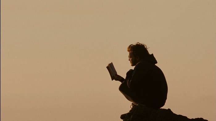 Christopher McCandless reading a book