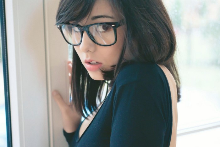 Woman with glasses wearing a black top