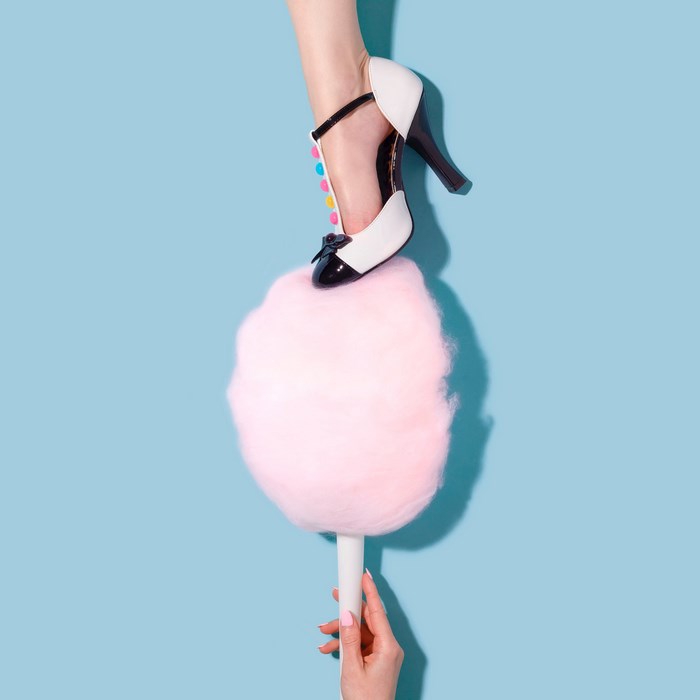 Woman's shoe on pink cotton candy