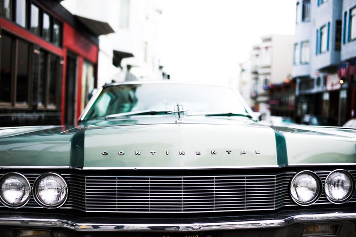 Green Lincoln Continental vintage car on a city street