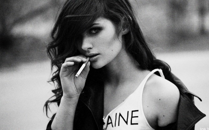 Woman smoking cigarette with hair in face
