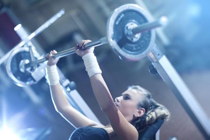 Woman lifting weights in a gym