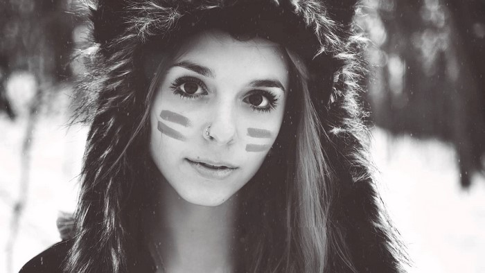 Woman with face paint and fluffy hat in winter