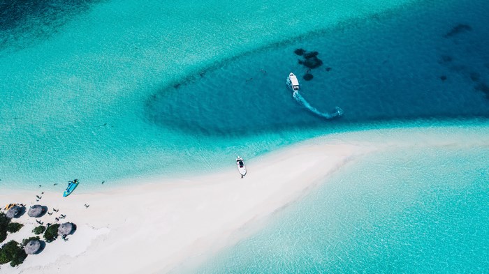 Aerial view of a sandbank with boats in the Maldives