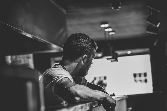Man with tattoo in a restaurant kitchen