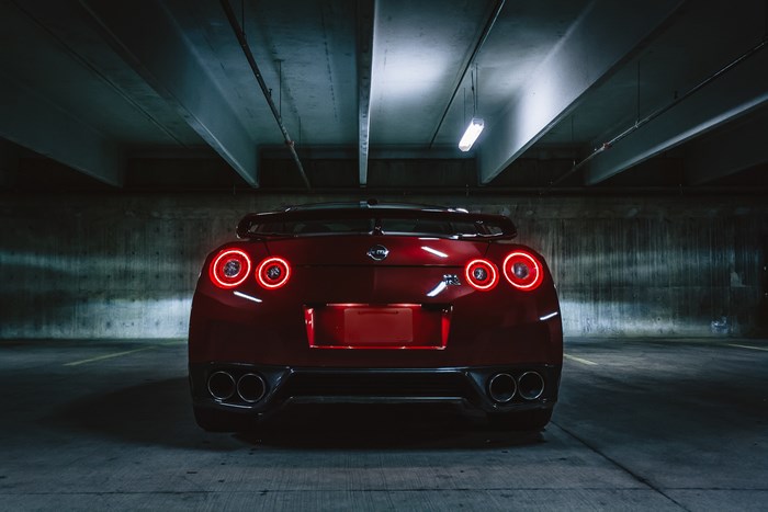 Red Nissan GTR parked in a dark garage