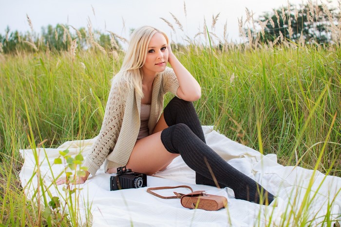 Woman in a field with a camera