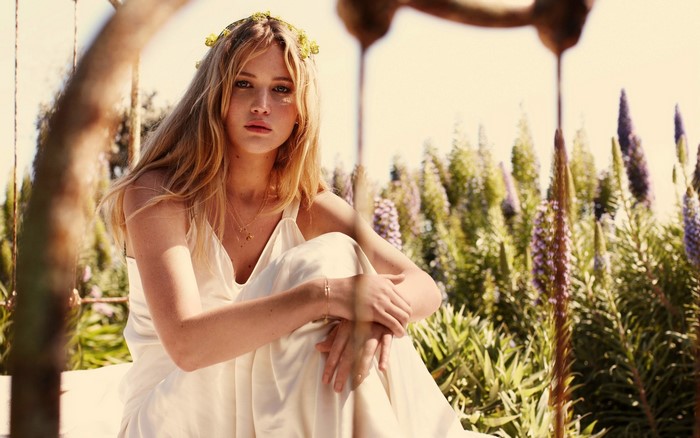 Jennifer Lawrence in a white dress with a flower crown