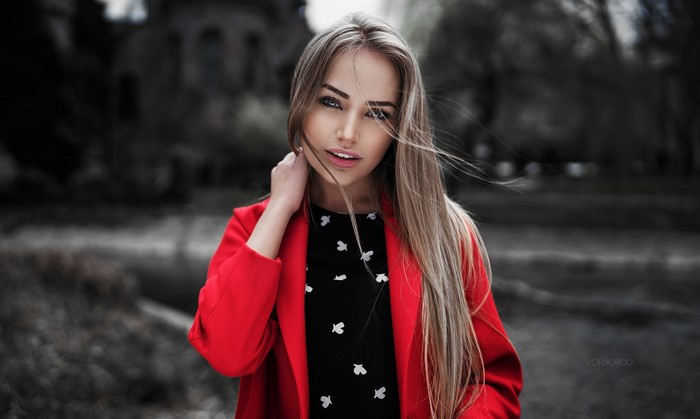 Woman with blonde hair in a red coat