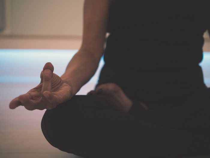 Person meditating in a yoga pose