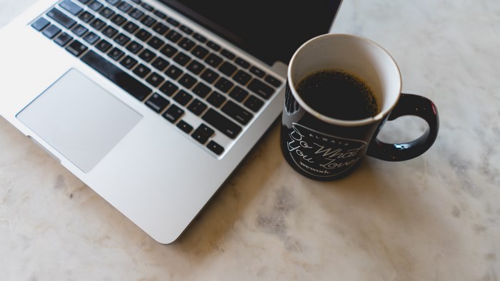Laptop and coffee mug with "Do What You Love" text