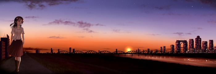 Girl walking by a city and bridge at sunset