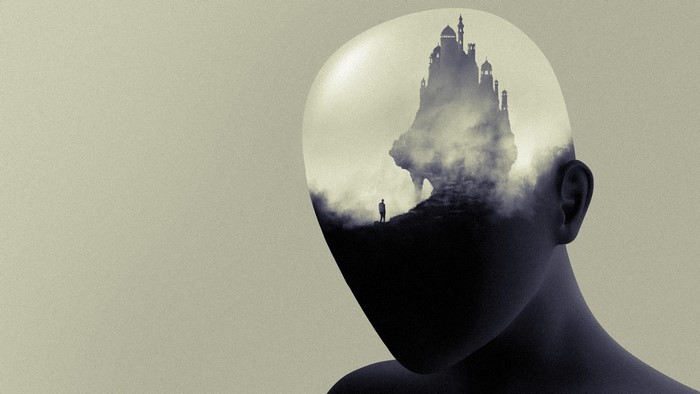 Double exposure of a head with a castle on a cliff