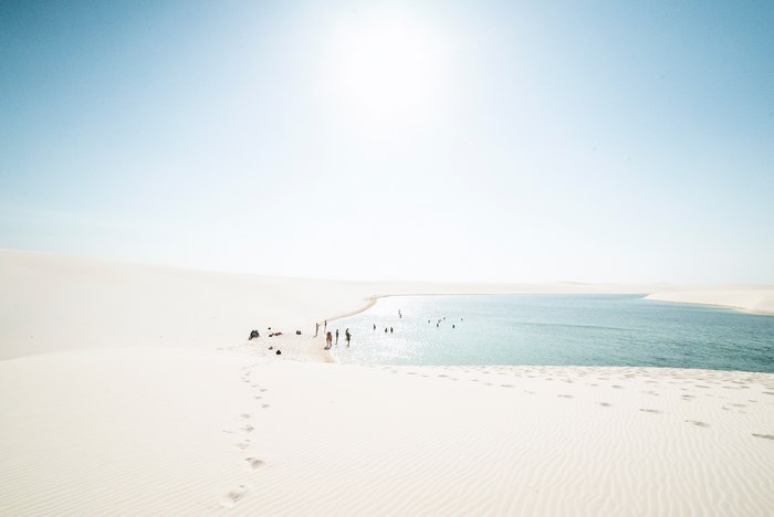People swimming in a lagoon in Lencois Maranhenses, Brazil
