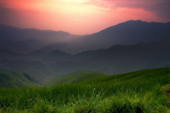 Sunset Over Rolling Green Hills and Misty Mountains