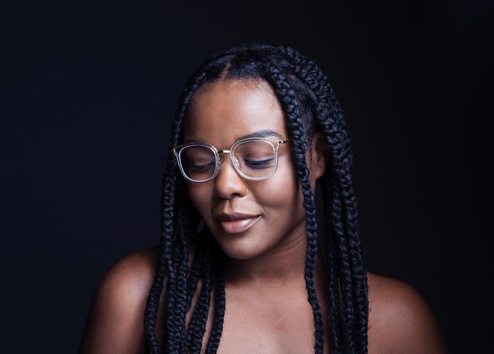 Smiling African American Woman with Braided Hair and Glasses