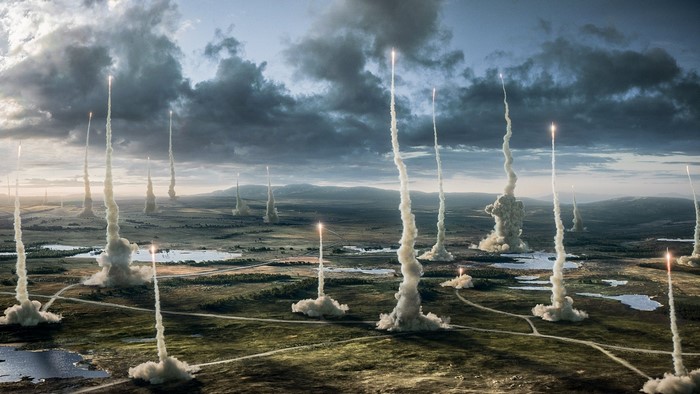 Multiple rockets launching from a landscape