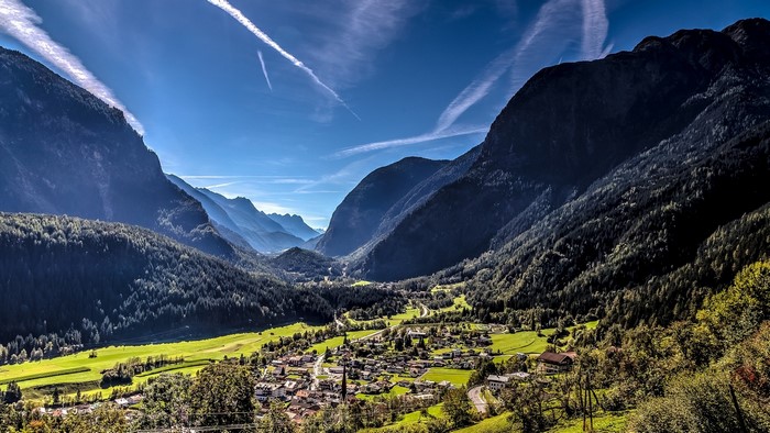 Sunlit Alpine Village in a Mountain Valley