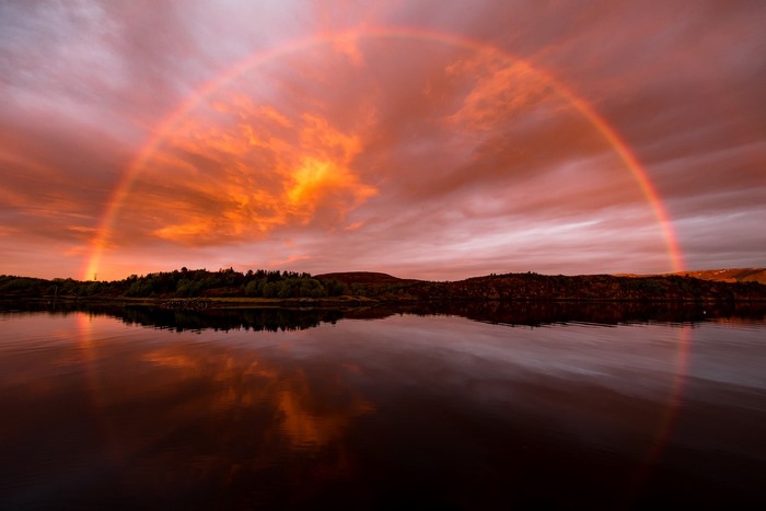Rainbow Arching Over Tranquil Lake and Forest