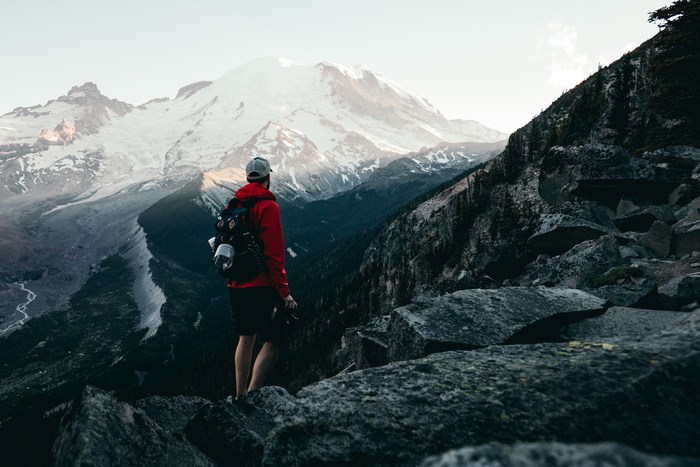 Man with backpack on rocky mountain overlook