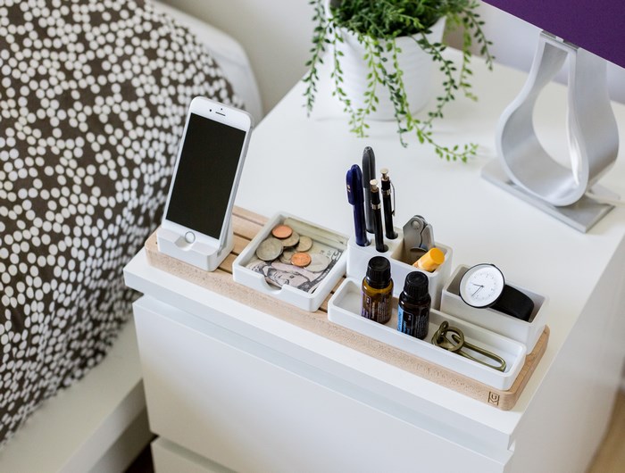 Nightstand organizer with iPhone, pens, coins, and watch