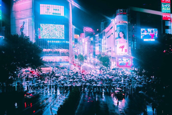 Crowded Tokyo Street at Night with Neon Lights and Umbrellas