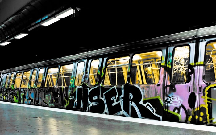 Graffiti-covered subway train at a station
