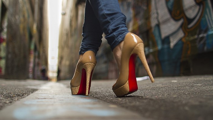Woman in high heels walking in alley