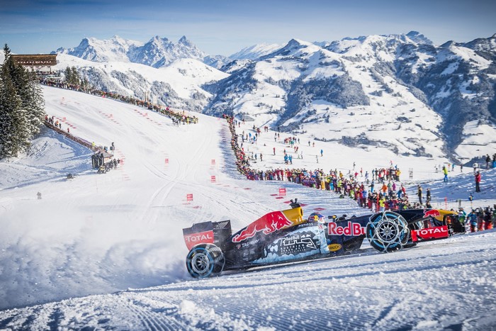 Formula 1 car racing on snow in mountains