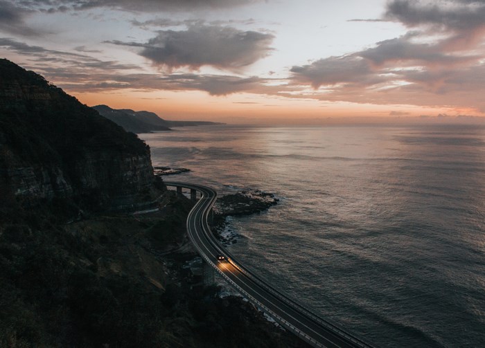 Sea Cliff Bridge at Dusk with Car Headlights