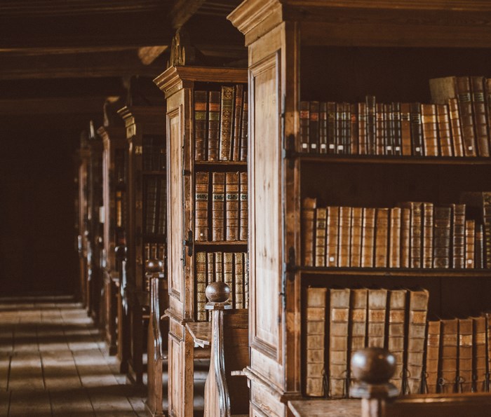 Old wooden library shelves filled with books