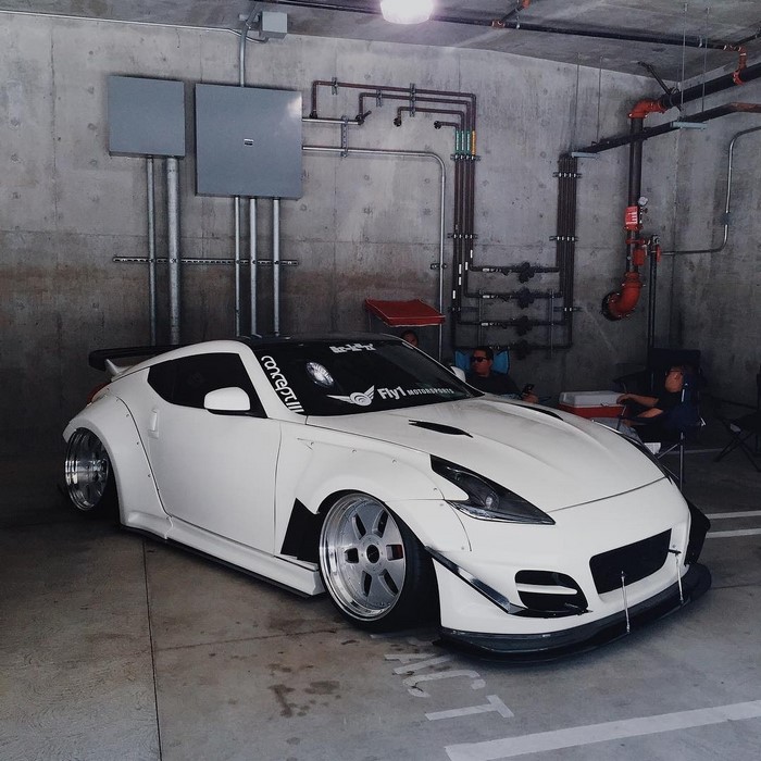 White Nissan 370Z with widebody kit in garage