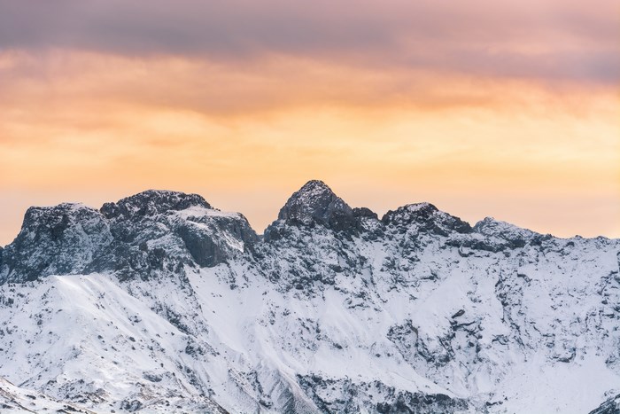 Snow-covered mountain range at sunset