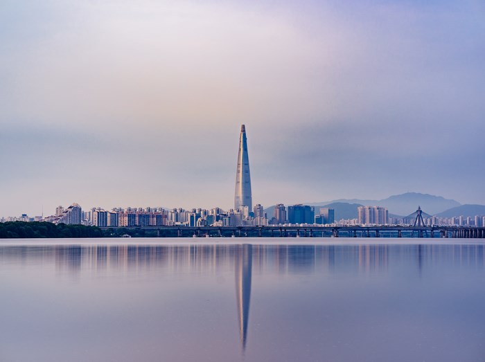 Seoul cityscape with Lotte World Tower and river reflection