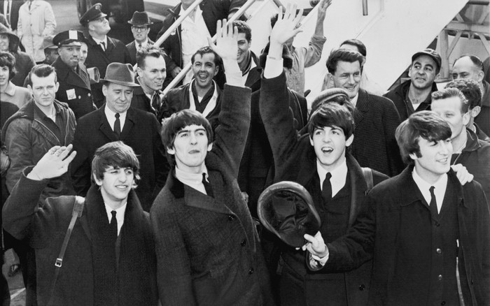 The Beatles waving to fans