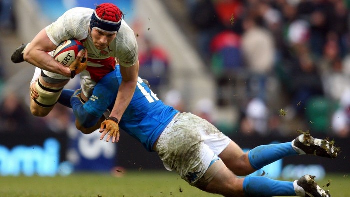 England rugby player tackled by Italy player