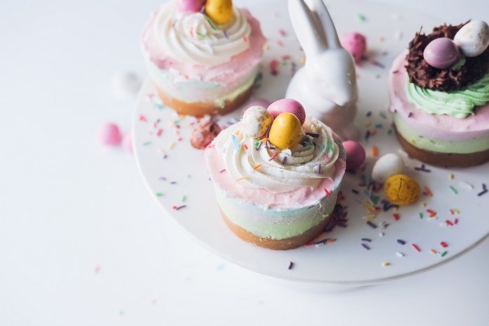 Easter cupcakes with chocolate eggs and a bunny figurine
