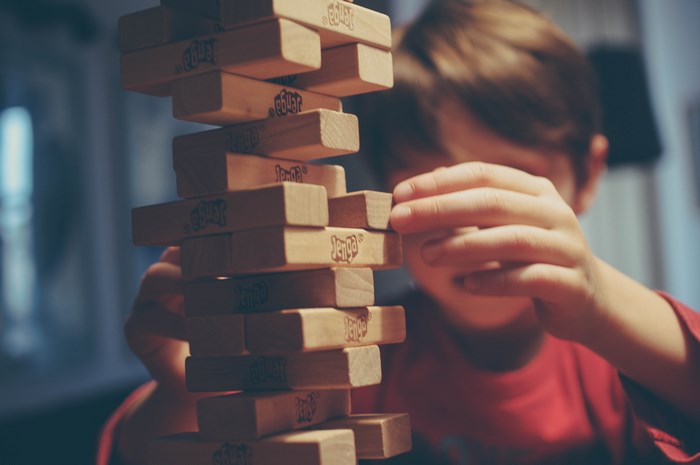 Boy playing Jenga game