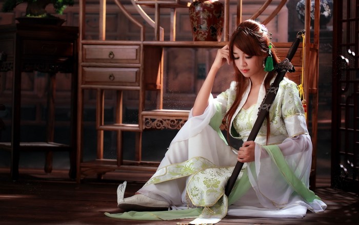 Asian Brunette Woman in Traditional Sword Costume
