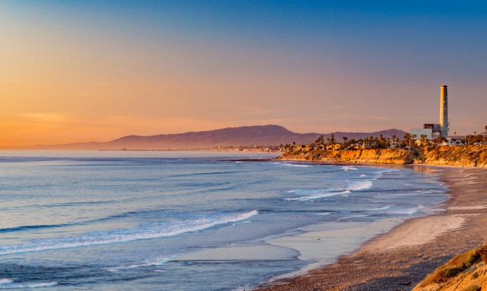 Sunset over the ocean and powerplant in San Diego