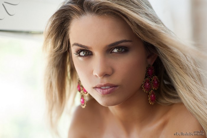 Close-up of Blonde Woman with Pink Earrings