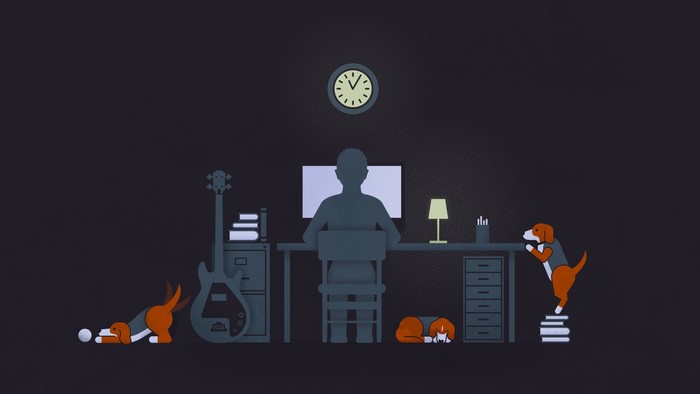 Minimalist desk with computer, guitar, and dogs