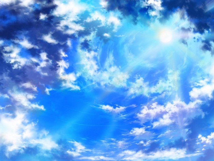 Sun rays shining through clouds in a blue sky