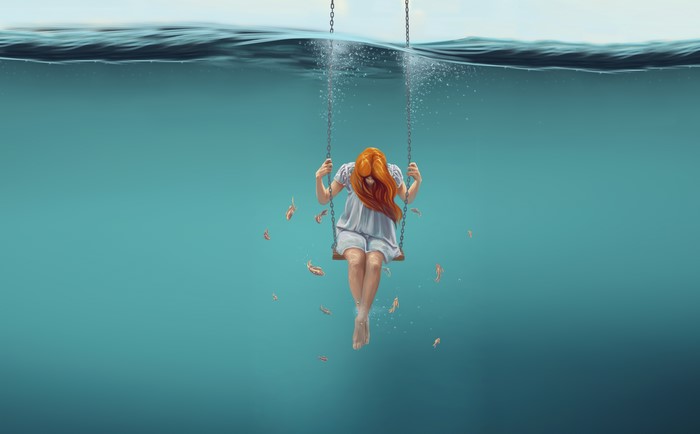 Girl on a swing underwater with fish