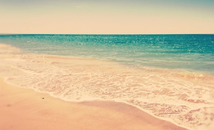 Beach with gentle waves and sand