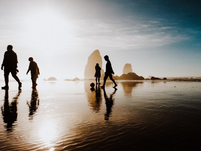People playing soccer on Cannon Beach at sunset