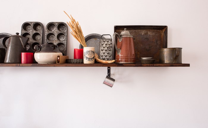 Vintage kitchen utensils on a wooden shelf