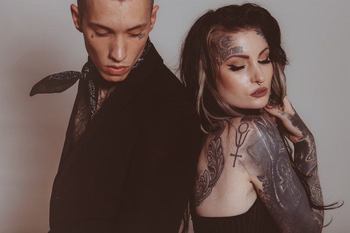 Man and woman with tattoos posing together