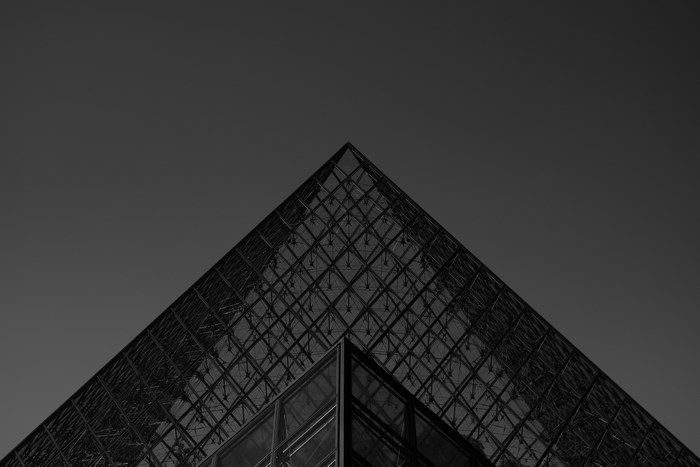 Louvre Pyramid architecture in black and white